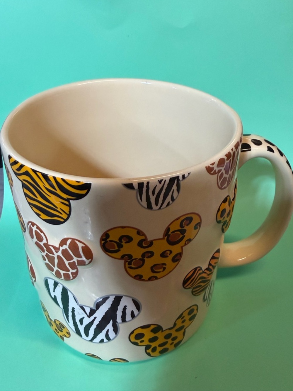 Disney Parks Ceramic Mug in Cream w/ Mickey Mouse heads safari style Markings